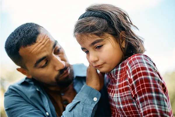 Father consoling daughter