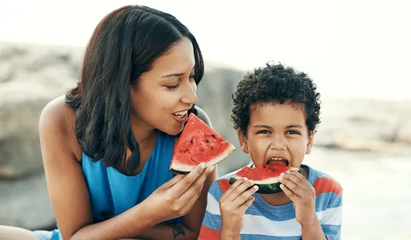 Mother and son eating watermelon