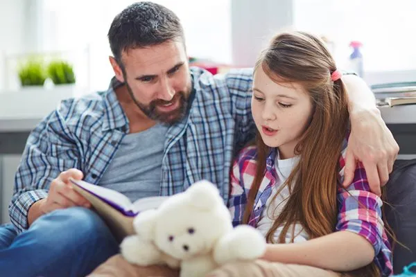 Daughter reading with father